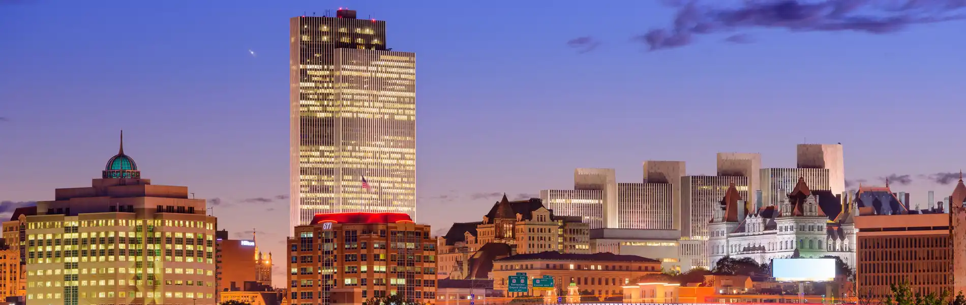 Neon color image of a band playing and people singing along
